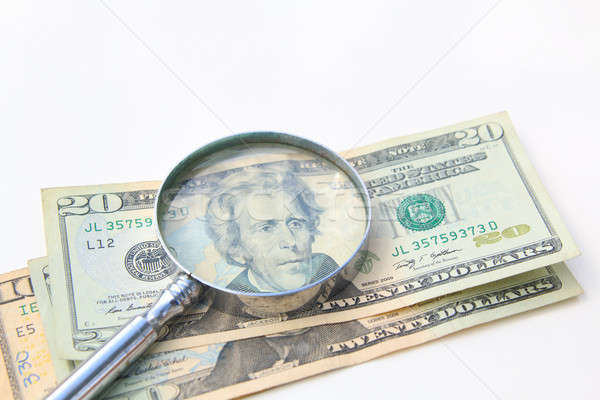 money under magnify glass isolated over white  Stock photo © alexmillos