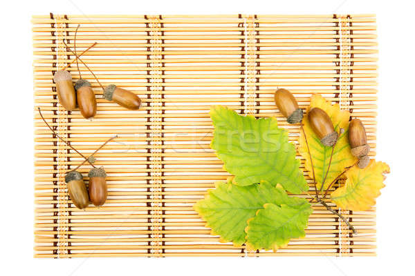 leaves of oak acorns on a mat from straw Stock photo © alinamd