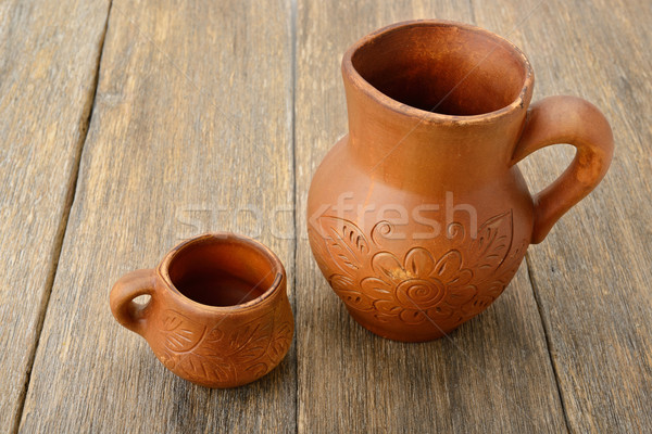 crock and a cup on a wooden surface Stock photo © alinamd