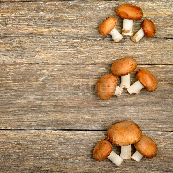 champignon mushrooms on a wooden boards background Stock photo © alinamd