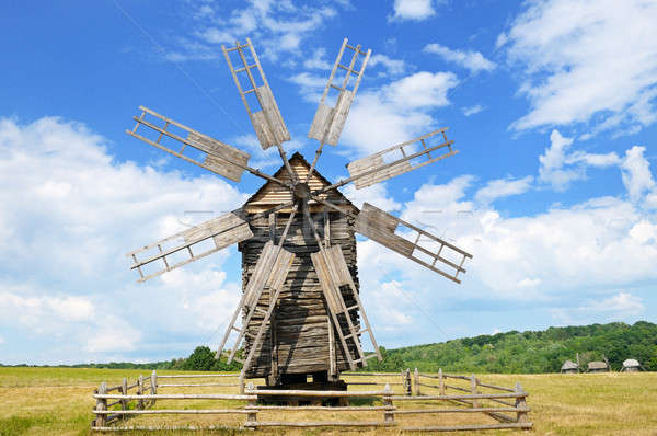 Stock photo: old wooden windmill in a field