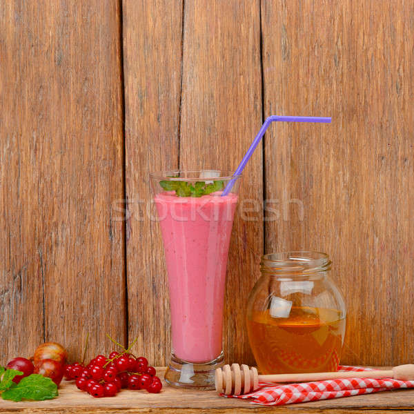berry smoothie, currants, gooseberries and honey on a wooden sur Stock photo © alinamd