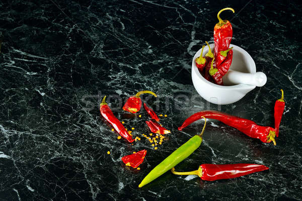 Red Hot Chili Peppers in mortar over dark background Stock photo © alinamd