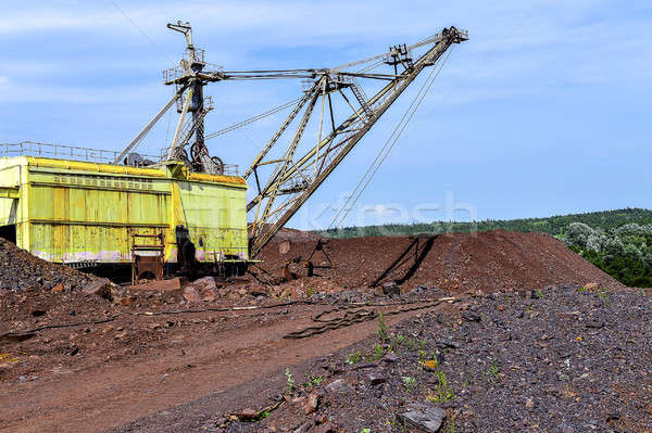 Excavator machine at excavation earthmoving work in quarry Stock photo © AlisLuch