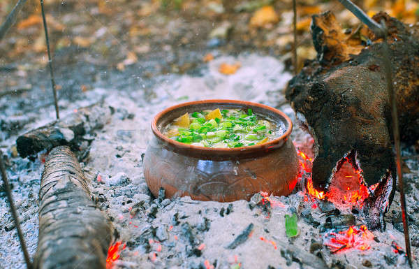 Roast in a clay pot on the fire Stock photo © AlisLuch