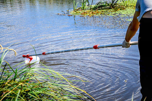 Take samples of water for laboratory testing. The concept - analysis of water purity, environment, e Stock photo © AlisLuch