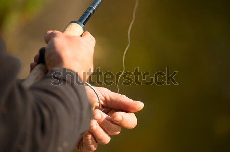 Stock photo: Spinning in the hands of the angler 