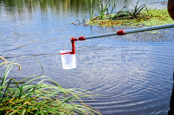 Take samples of water for laboratory testing. The concept - analysis of water purity, environment, e Stock photo © AlisLuch