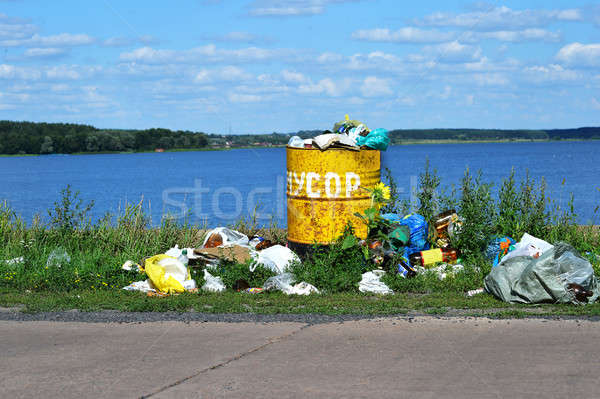 Overflowing barrel with rubbish and waste disposal on the waterf Stock photo © AlisLuch