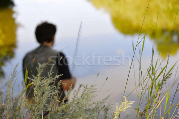 Blurred silhouette of fisherman on the river on a clear summer d Stock photo © AlisLuch