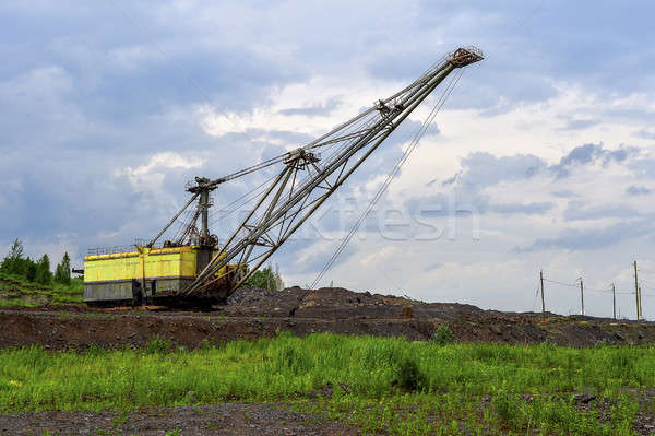 Excavator machine at excavation earthmoving work in quarry Stock photo © AlisLuch