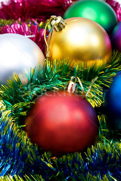 Stock photo: Multi-colored Christmas tree balls in the tinsel 