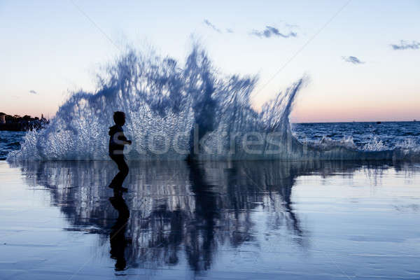 Child on the seafront running away from the waves Stock photo © All32