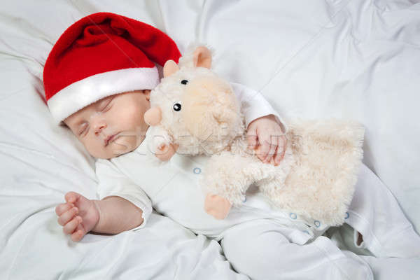 Baby in Christmas hat asleep hugging favorite toy Stock photo © All32