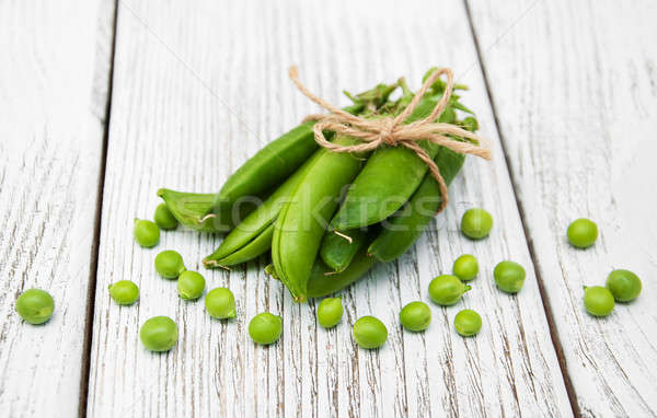 Stock photo: green peas on a table