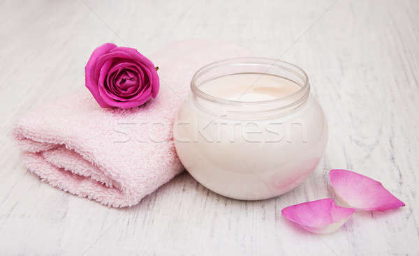 spa essentials cream with towels and rose Stock photo © almaje