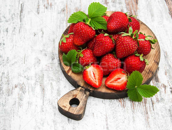 Fresh strawberries on a board Stock photo © almaje