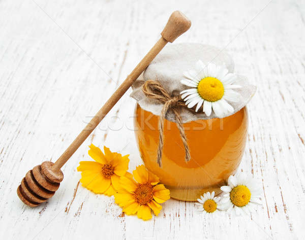 Jar of honey with camomile Stock photo © almaje