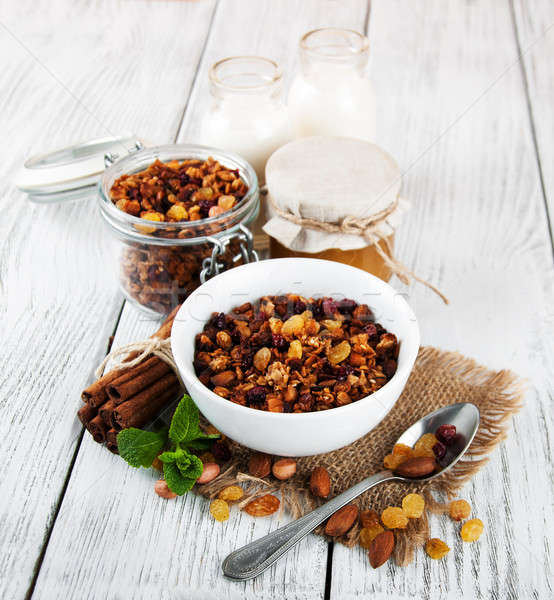 Házi készítésű granola diók tej méz fa asztal Stock fotó © almaje