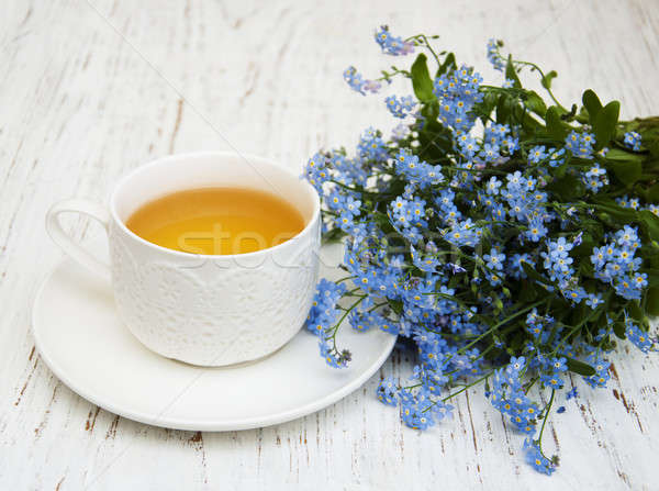 Cup of teand forget me not flowers Stock photo © almaje
