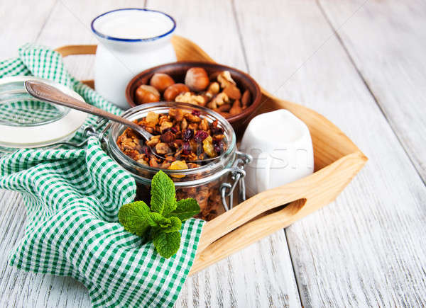 Házi készítésű granola diók tej fa asztal gyümölcs Stock fotó © almaje