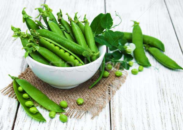 Stock photo: green peas on a table