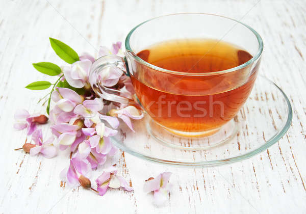 Cup of tea and acacia flowers Stock photo © almaje