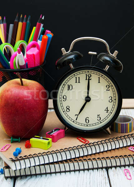 Iskola irodaszerek fa asztal könyv óra alma Stock fotó © almaje