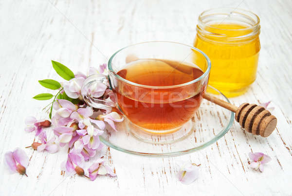 Cup of tea and acacia flowers Stock photo © almaje
