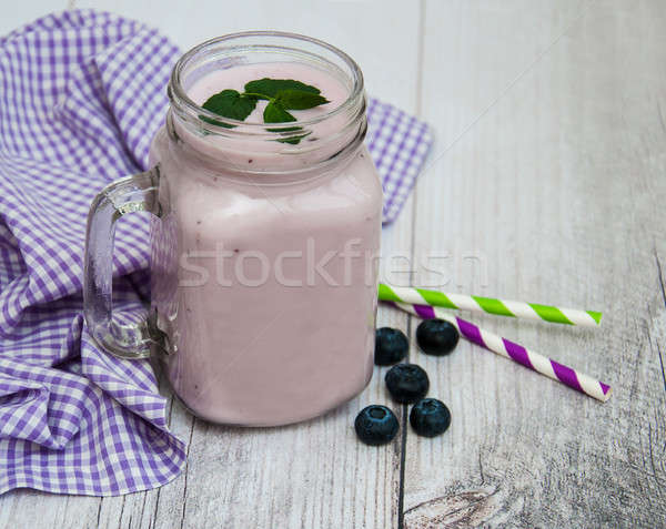 Glass with blueberry yogurt Stock photo © almaje