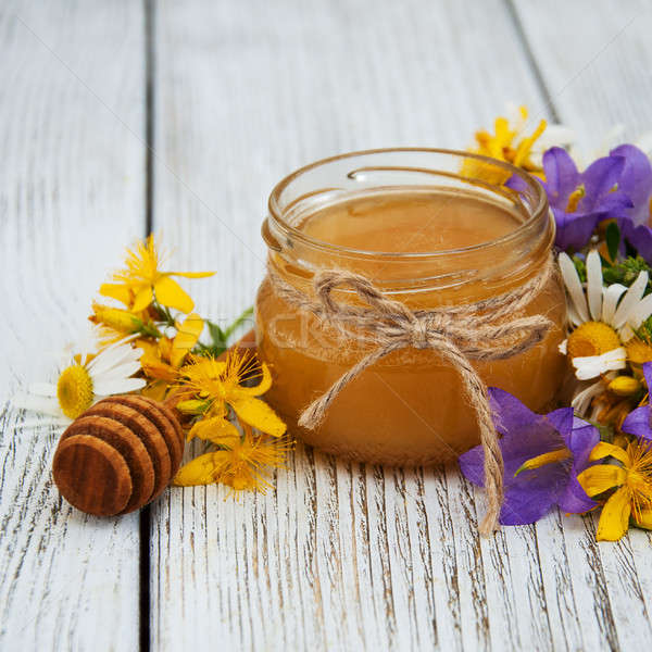 Bögre méz vadvirágok öreg fa asztal virág Stock fotó © almaje