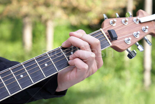 Játszik gitár közelkép lövés fiatalember férfi Stock fotó © AlphaBaby