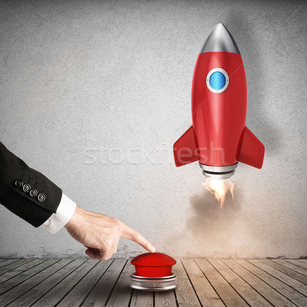 Businessman launches rocket pushing a red button. 3D Rendering Stock photo © alphaspirit