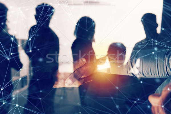 Handshaking business person in office with network effect. concept of teamwork and partnership. doub Stock photo © alphaspirit