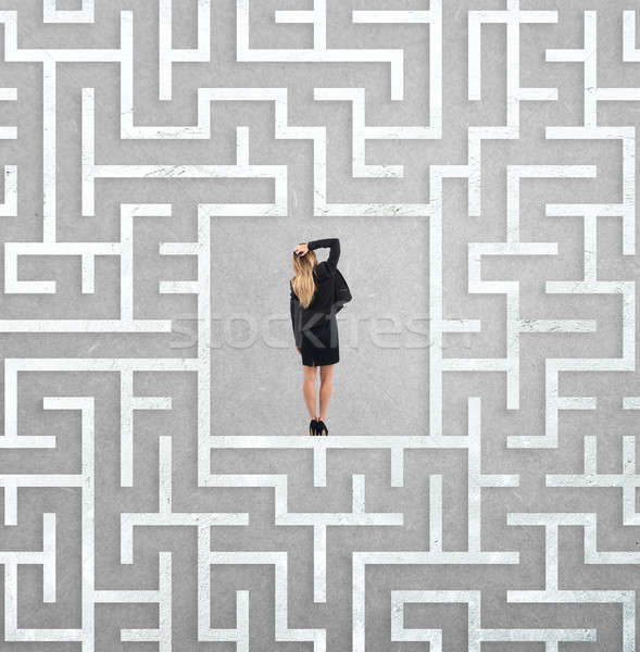 Confused businesswoman at the center of a maze Stock photo © alphaspirit