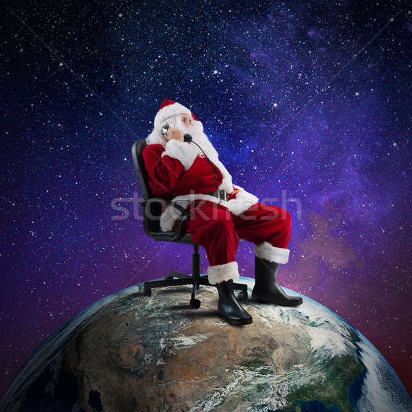 Kerstman telefoon vergadering stoel groot wereld Stockfoto © alphaspirit