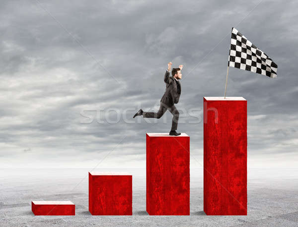 Businessman reaches glory on a statistical scale Stock photo © alphaspirit