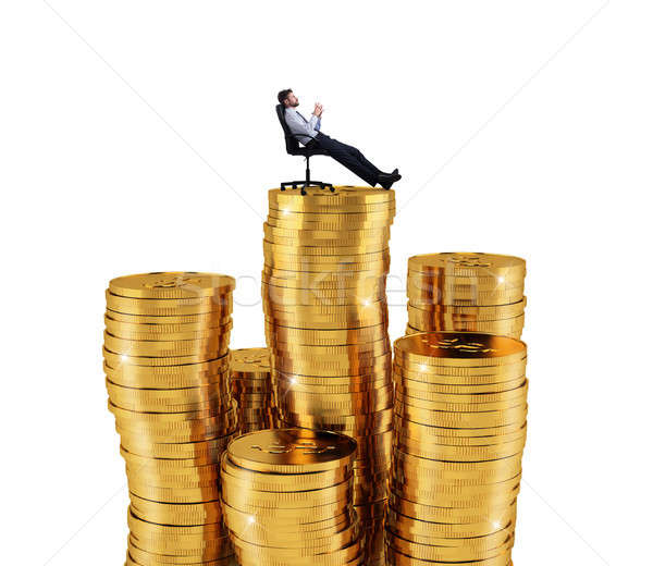 Successful businessman relaxing over piles of money. Concept of success and company growth Stock photo © alphaspirit