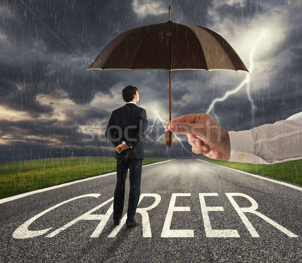 Businessman ready to start a difficult career way with a big help of an umbrella. concept of support Stock photo © alphaspirit
