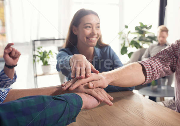 Business people putting their hands together. Concept of teamwork and partnership Stock photo © alphaspirit