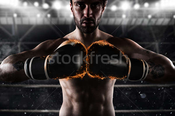 Confident boxer with fiery boxing gloves Stock photo © alphaspirit