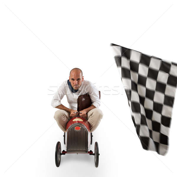 Stock photo: Successful businessman in a small car on the finishing line