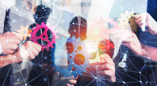 Business team connect pieces of gears. Teamwork, partnership and integration concept with network ef Stock photo © alphaspirit
