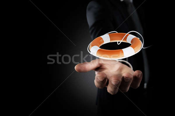 Businessman that hold a lifebelt. Concept of insurance and help in your business Stock photo © alphaspirit