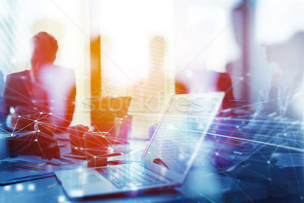 Teamwork works with a laptop. Concept of internet sharing and interconnection. double exposure Stock photo © alphaspirit