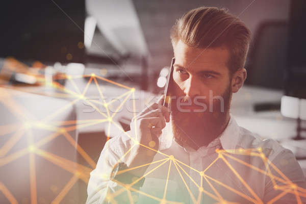 Businessman talking to the phone in office Stock photo © alphaspirit