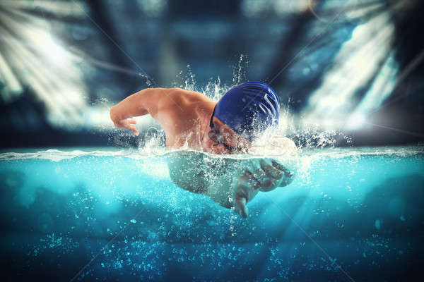 Athlete swims in a blue deep pool Stock photo © alphaspirit