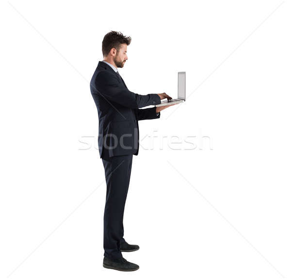 Businessman connected on internet network with his laptop. Isolated on white background Stock photo © alphaspirit