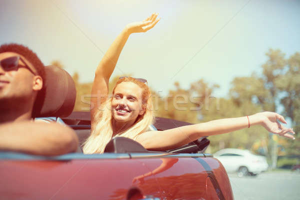 Young woman in cabriolet car departs for the summer holidays Stock photo © alphaspirit