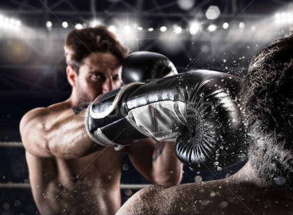 Stock photo: Boxer in a boxe competition beats his opponent